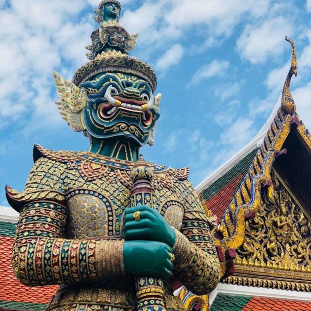 gold and blue dragon statue under blue sky during daytime