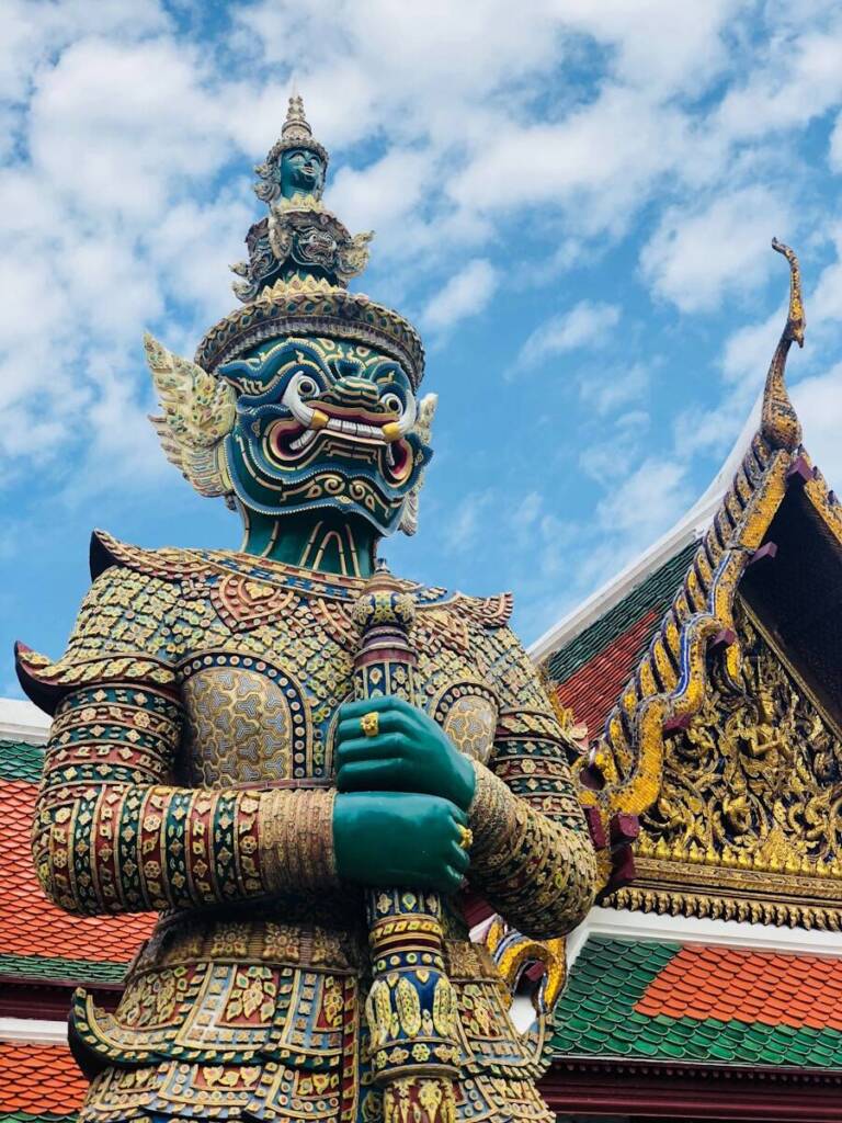 gold and blue dragon statue under blue sky during daytime