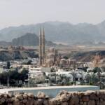 a view of a city with mountains in the background